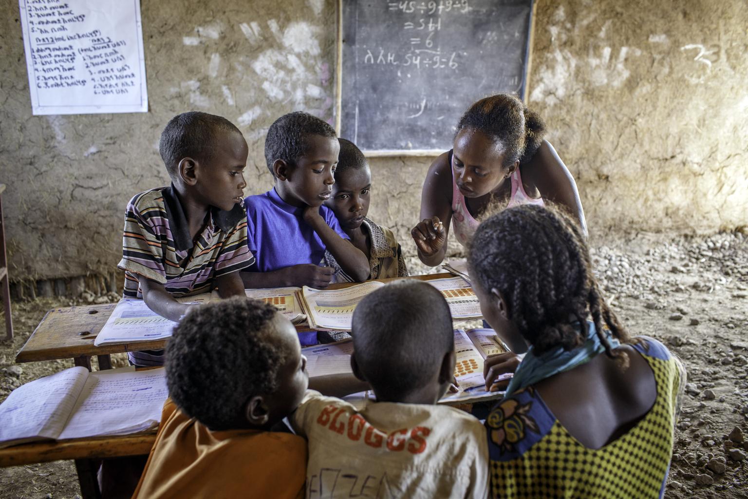 Yeglime Mebrtu, helps pupils at Alula ABEC (Alternative Basic Education Center)  - presently upgraded as a primary school, in Afar region of Ethiopia Tuesday 8 April, 2014. 

Pastorlist in Afar and Oromia region of Ethiopia, Alternative Basic Education Center